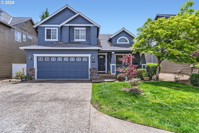 craftsman-style home with a garage and a front lawn