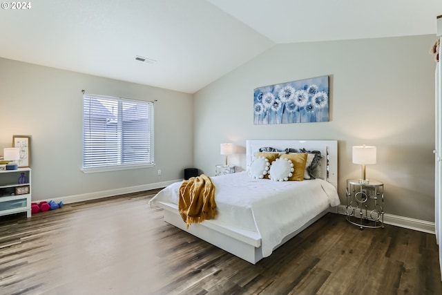 bedroom with dark hardwood / wood-style floors and lofted ceiling