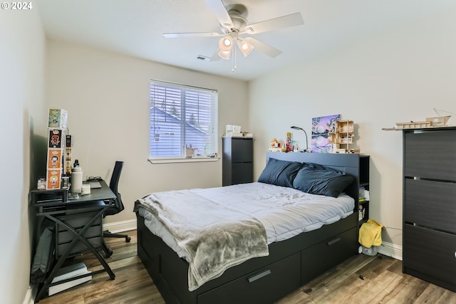 bedroom with hardwood / wood-style floors and ceiling fan