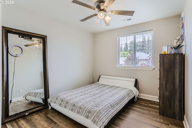 bedroom with ceiling fan and dark hardwood / wood-style floors