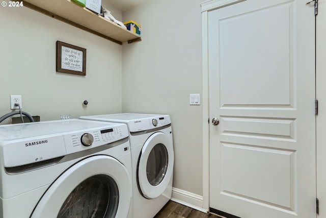 laundry area with washer and dryer and dark hardwood / wood-style flooring