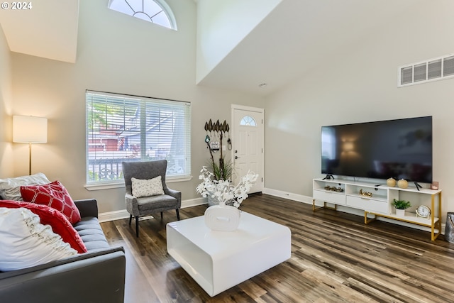 living room with dark hardwood / wood-style flooring and high vaulted ceiling