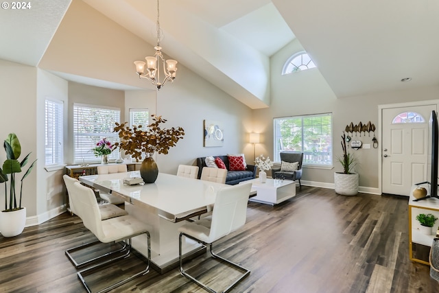 dining space featuring plenty of natural light, dark hardwood / wood-style flooring, high vaulted ceiling, and a chandelier