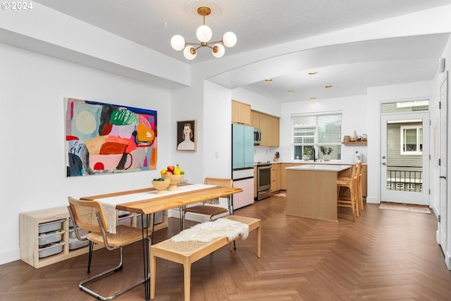 dining room with dark parquet flooring and a notable chandelier