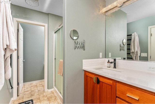 bathroom featuring vanity and a shower with shower door