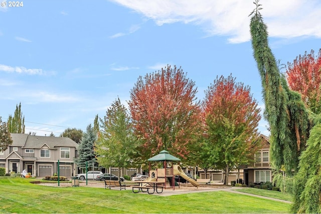 view of community featuring a playground and a lawn