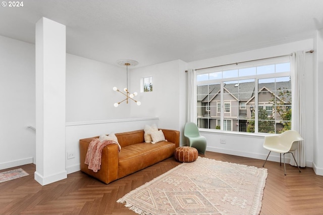 living area with an inviting chandelier and parquet floors