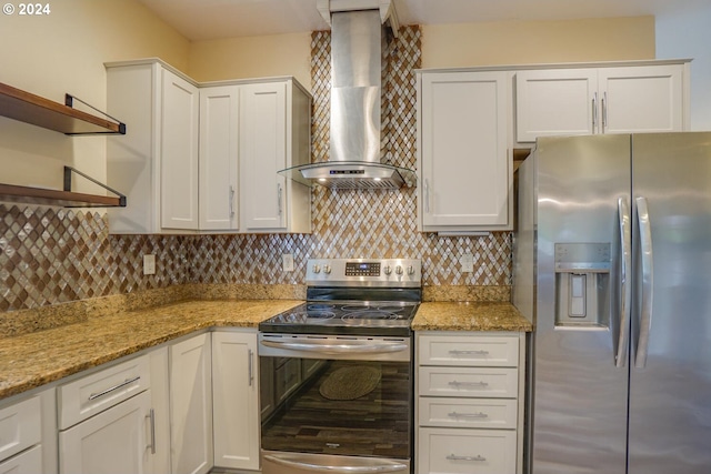 kitchen with wall chimney exhaust hood, white cabinetry, and appliances with stainless steel finishes