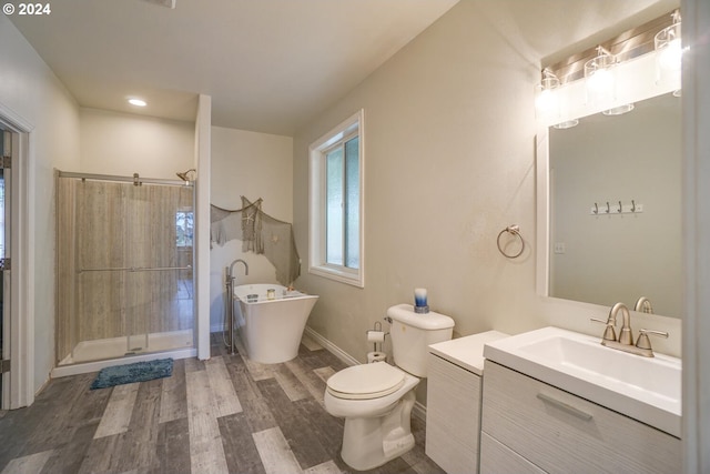 full bathroom featuring toilet, separate shower and tub, hardwood / wood-style flooring, and vanity