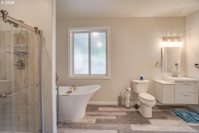 full bathroom with wood-type flooring, separate shower and tub, toilet, and vanity