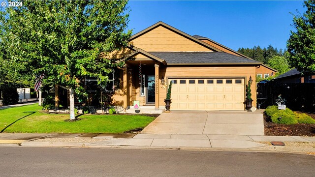 view of front of house with a garage and a front lawn