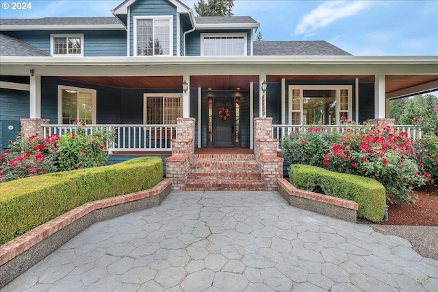 property entrance featuring covered porch