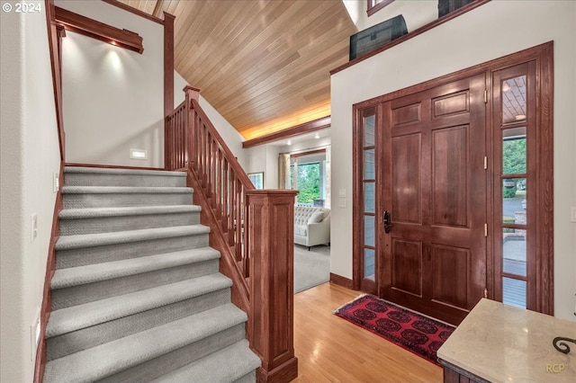 foyer featuring wood ceiling, lofted ceiling, and light wood-type flooring