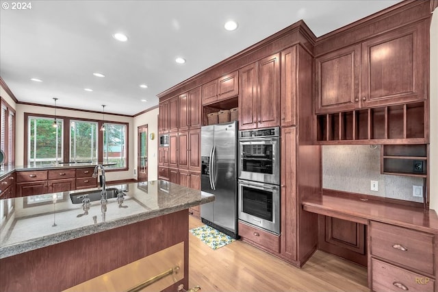 kitchen with crown molding, appliances with stainless steel finishes, sink, light wood-type flooring, and light stone counters