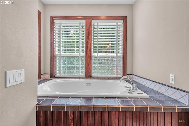 bathroom featuring a relaxing tiled tub