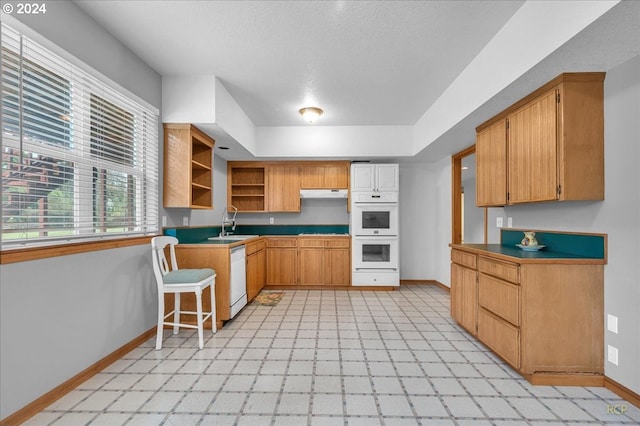 kitchen featuring sink and white appliances