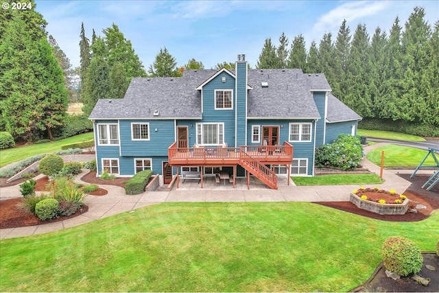 back of house with a patio area, a deck, and a lawn