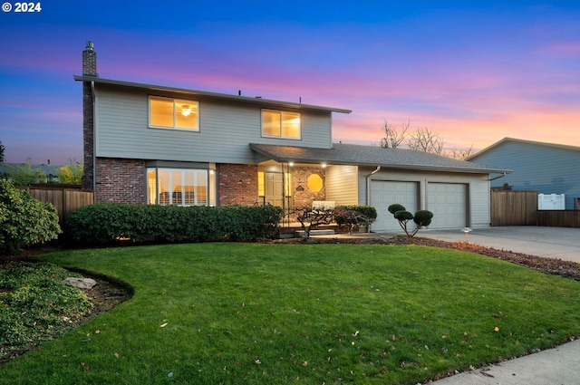 front facade featuring a yard and a garage