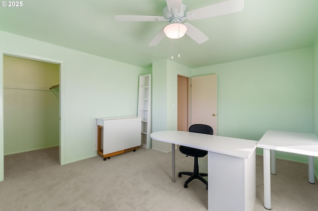 carpeted home office featuring ceiling fan