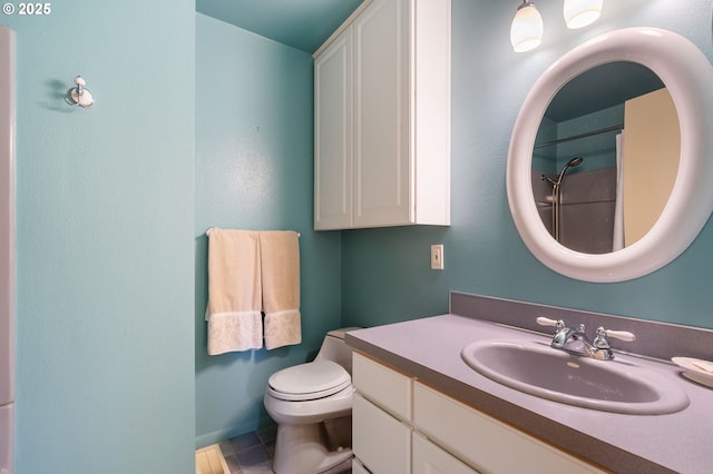 bathroom with tile patterned flooring, a shower, vanity, and toilet