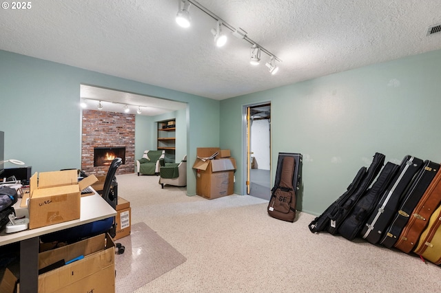 office area featuring a textured ceiling and a brick fireplace