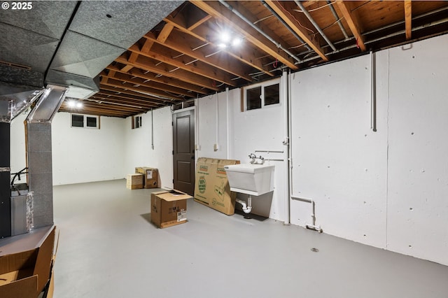 basement with sink and heating unit