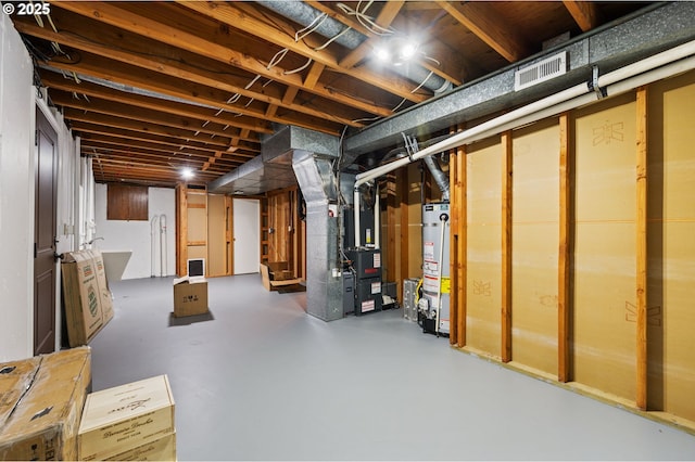 basement with water heater and heating unit