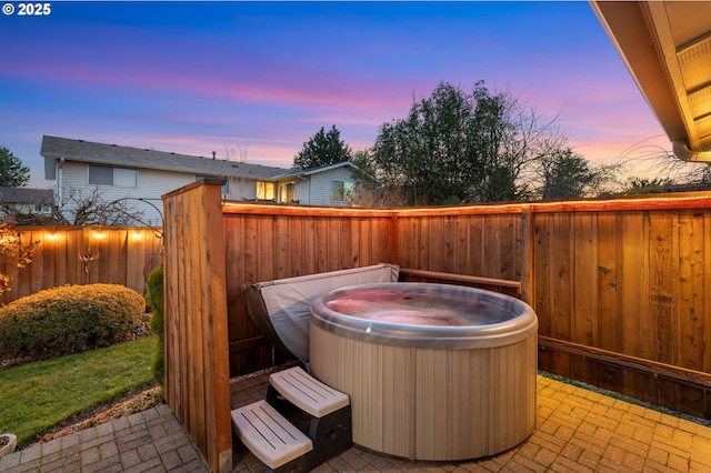 patio terrace at dusk with a hot tub