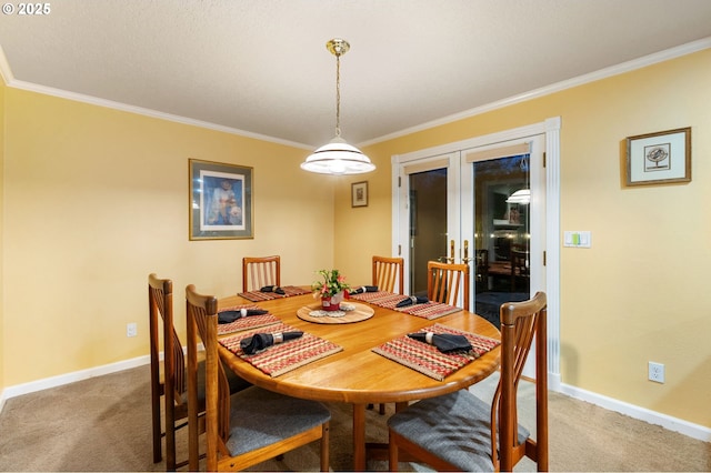 dining area with crown molding, french doors, and carpet floors