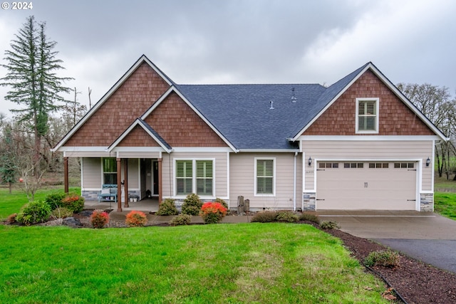 craftsman-style house with a garage, covered porch, and a front lawn