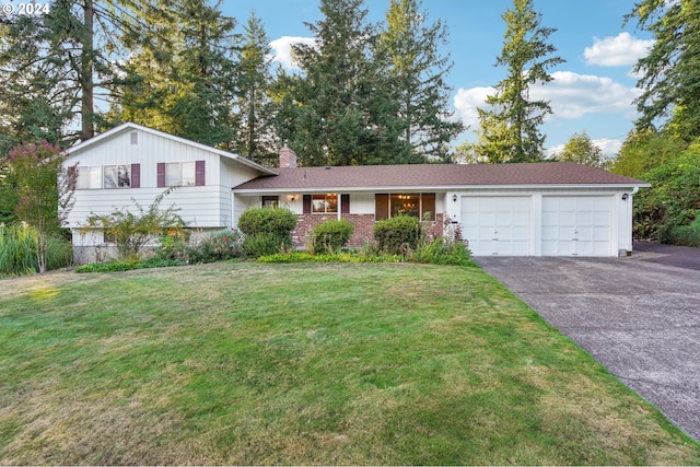 split level home featuring a front yard and a garage