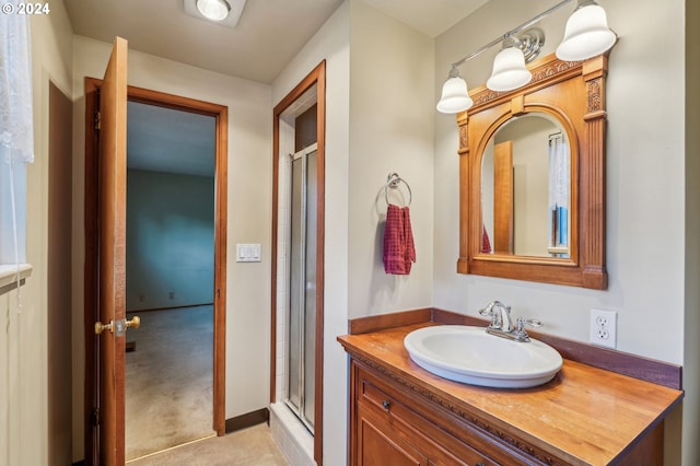 bathroom featuring vanity and a shower with shower door