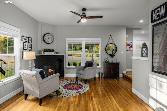 living room with plenty of natural light, hardwood / wood-style floors, and ceiling fan