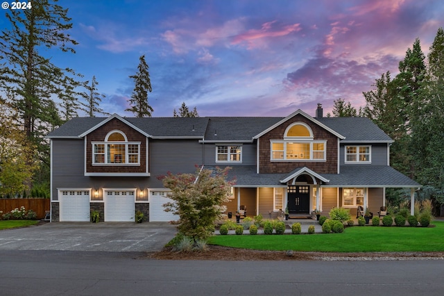 view of front of property featuring a yard and a garage