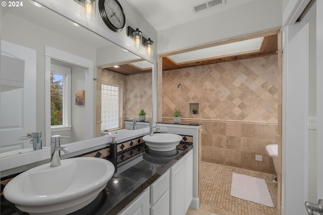 bathroom with vanity, a bathtub, and tile patterned floors