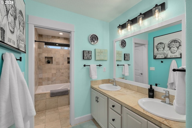 bathroom with vanity, tiled shower / bath combo, and tile patterned flooring