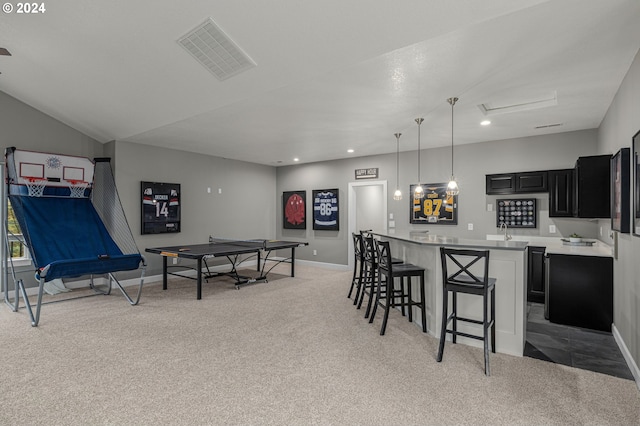 game room with light colored carpet and bar