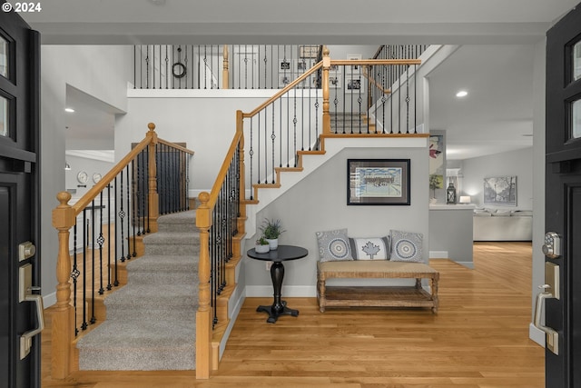 stairs featuring hardwood / wood-style floors