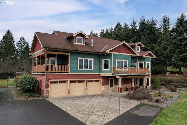 view of front of home featuring a balcony and a garage