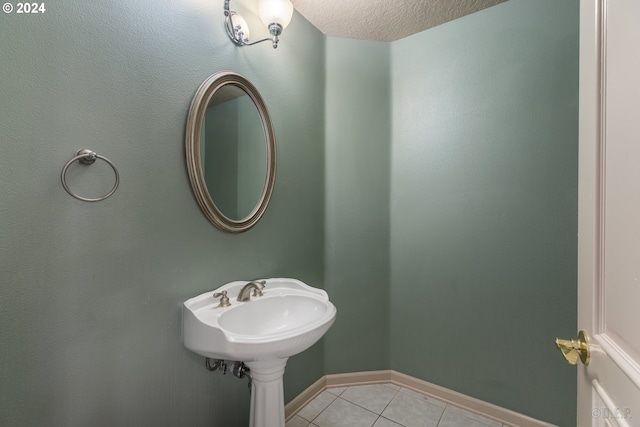 bathroom featuring tile patterned floors and a textured ceiling