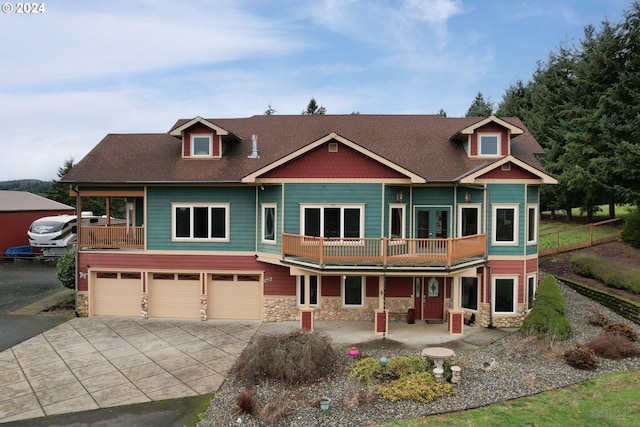 view of front of property featuring a balcony and a garage