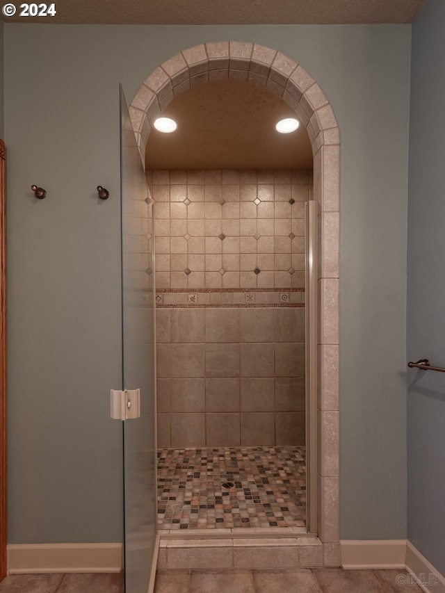 bathroom with a shower with door