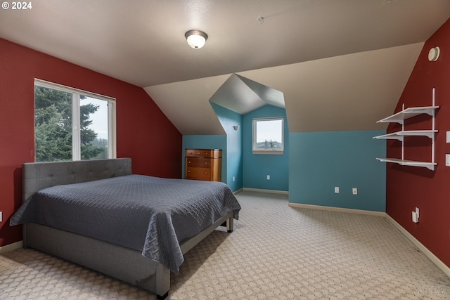 bedroom with carpet floors, vaulted ceiling, and multiple windows