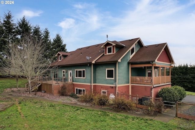 back of house featuring a yard, a balcony, and central AC