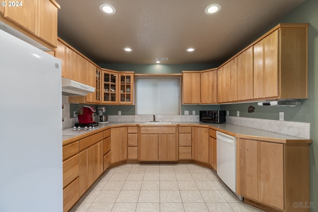 kitchen with light brown cabinets, white appliances, sink, and light tile patterned floors