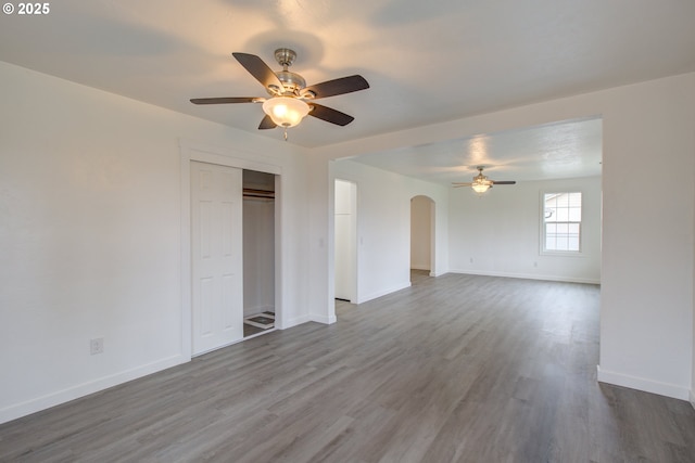 empty room with ceiling fan and hardwood / wood-style floors