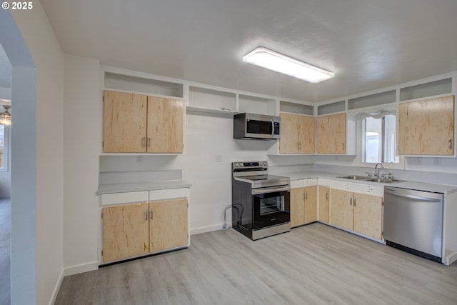 kitchen with sink, stainless steel appliances, light hardwood / wood-style flooring, and light brown cabinetry