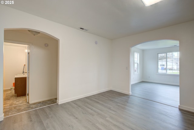 spare room with light hardwood / wood-style floors