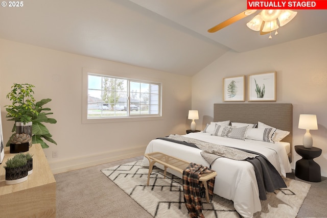 carpeted bedroom featuring ceiling fan and vaulted ceiling