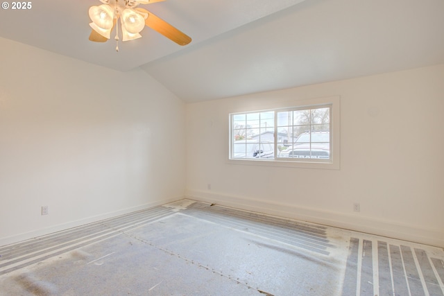 empty room with ceiling fan and vaulted ceiling